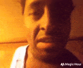 a close up of a man 's face with a magic hour logo on the bottom .