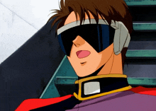a close up of a man wearing goggles and a purple jacket