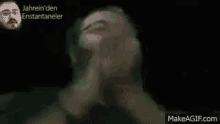 a man with a beard is screaming with his arms in the air