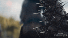 a poster for predator badlands shows a cactus with spikes on it