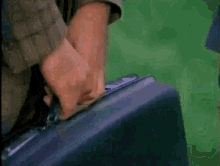 a man and a woman are holding a briefcase in their hands