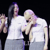 two girls in school uniforms are standing next to each other with the letters ld on the bottom