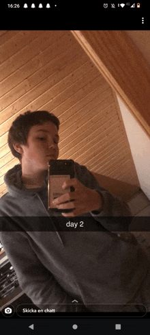a person taking a picture of themselves in a mirror with the words day 2 below them