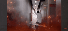a man in a white shirt is in a hallway with the word kebakaran written on the bottom
