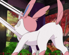 a pink and white cartoon bunny with a blue ear