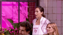 a woman wearing an apron that says tamara on it