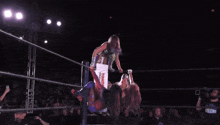 two women wrestling in a ring with a sign behind them that says ' yokohama '