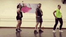 three people are dancing together in a dance studio .