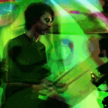 a blurry picture of a man playing a drum set
