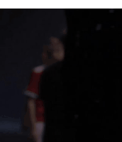 a blurry picture of a person in a red shirt