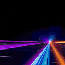 a purple and blue light is coming out of a dark tunnel