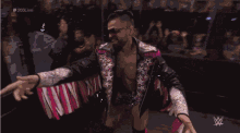 a blurry picture of a wrestling match with a w logo on the bottom right