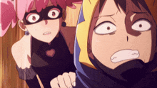 a girl in a mask stands next to a boy in a hood