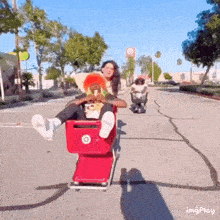 a woman sits in a red shopping cart with a target logo