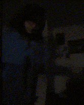 a blurry picture of a person 's face in a dark room .