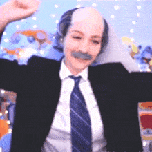 a man in a suit and tie is wearing a fake bald head .