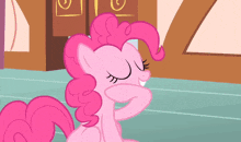 pinkie pie from my little pony standing on a blue floor