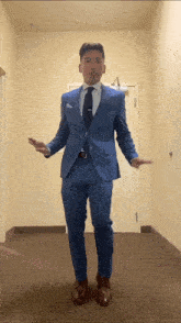 a man in a blue suit and tie is dancing