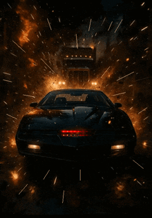 a black car is driving down a dark street with a truck behind it
