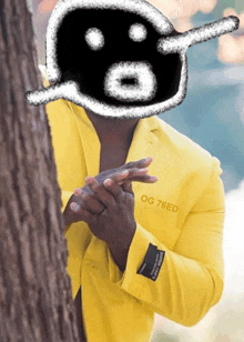 a man wearing a yellow jacket with og 76ed written on the sleeve