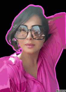 a woman wearing sunglasses and a pink shirt has a pink border