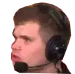 a man wearing headphones with a microphone on his head is making a funny face .