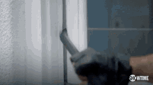 a close up of a person holding a gun in front of a door .
