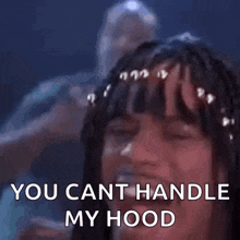 a woman with braids in her hair is laughing and saying `` you cant handle my hood '' .