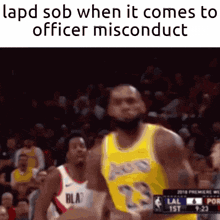 a basketball player in a yellow lakers jersey is running towards a police officer