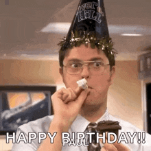 a man wearing a party hat and glasses is eating a cake .