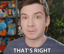 a man is saying that 's right in front of a shelf full of stuffed animals
