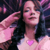 a woman wearing a necklace with a pixelated heart on it