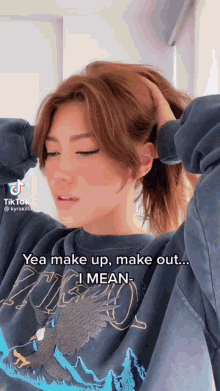 a woman wearing a sweatshirt that says yea make up make out ... i mean