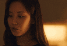 a close up of a woman 's face with a light in the background