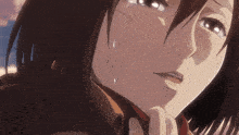 a close up of a woman 's face with a tear coming out of her eye