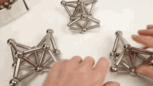 a person is playing with a set of magnetic balls