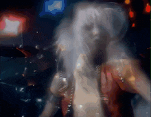a blurred image of a woman with white hair