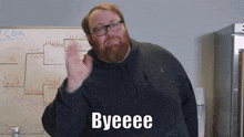 a man with a beard and glasses says byeeee in front of a whiteboard