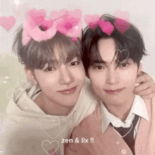 a couple of young men are standing next to each other with hearts on their heads .