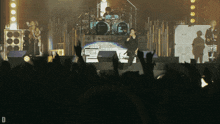 a group of people standing in front of a stage with a drum set that says ' yamaha ' on it