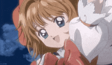 a girl with brown hair and blue eyes is holding a white cat