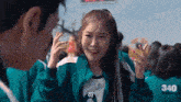 a girl in a green jacket with the number 340 on it