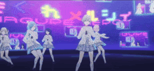 a group of anime girls are dancing in front of a sign that says equipe