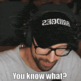 a man wearing glasses and a hat with the words you know what written on it