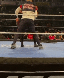 a man in an american nightmare jacket is boxing in a boxing ring