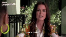 a woman says oh my god in front of a sign that says real housewives out of context