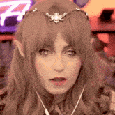 a close up of a woman 's face with the letter f visible in the background