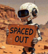 a robot holds a sign that says spaced out