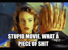 a picture of a woman and a man with the words stupid movie what a piece of shit