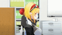 a girl with yellow hair is sitting in front of a bookshelf